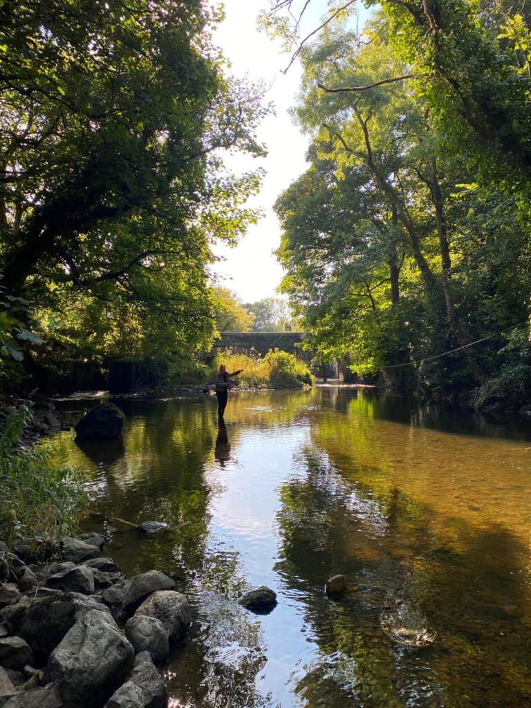 Local guide, Alex Joyce fly fishing alone on a scenic river in the Burren during Burren flyfishing trips in Ireland.
