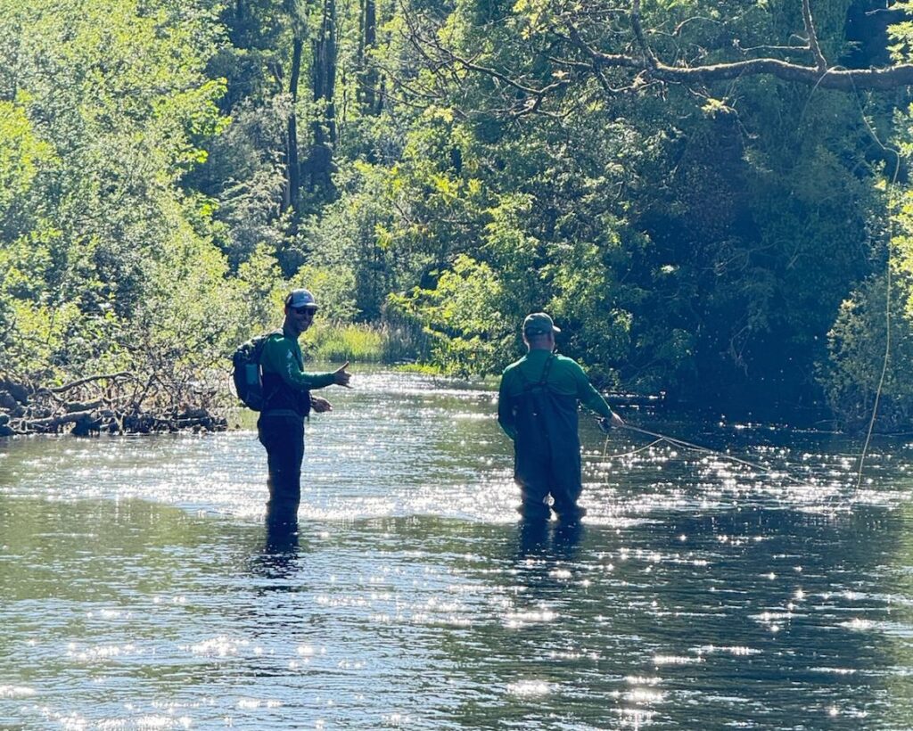 Alex Joyce guiding a client fly fishing on a scenic Connemara river during Connemara Fly Fishing Trips